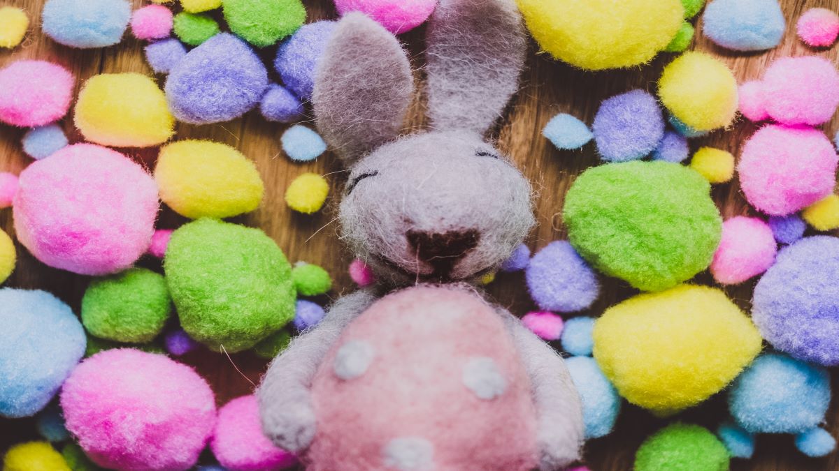 A felt Easter bunny surrounded by felt Easter eggs