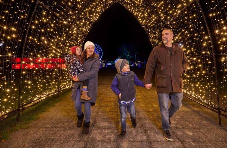 A family enjoys a Christmas lights trail