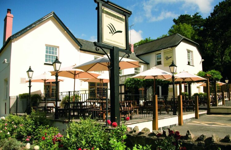 Exterior of the Malvern Hills Hotel including terrace area with tables and parasols