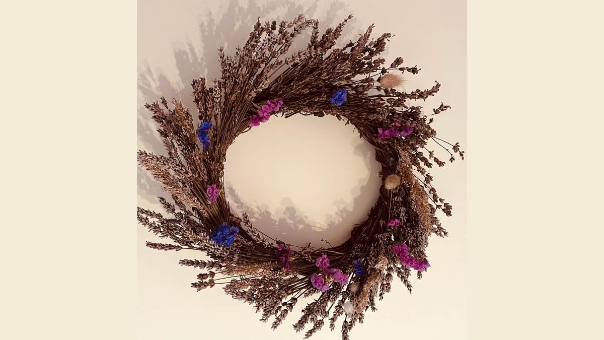 A floral wreath featuring blue and purple flowers