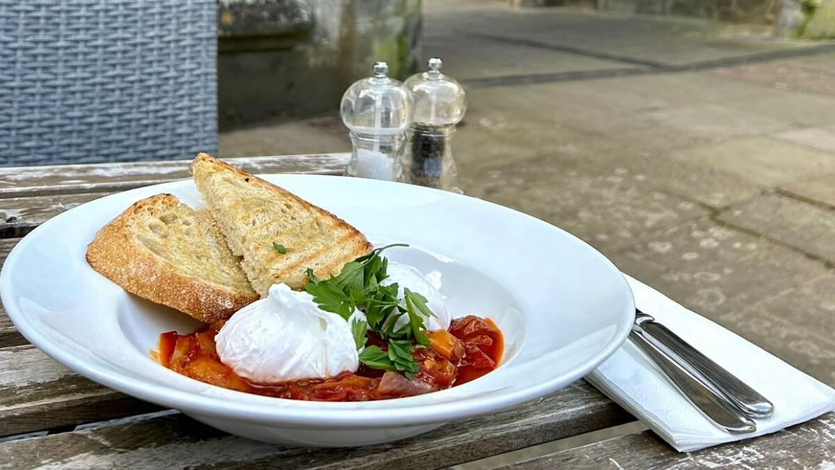 A dish from Mac and Jac's served outside at wooden table