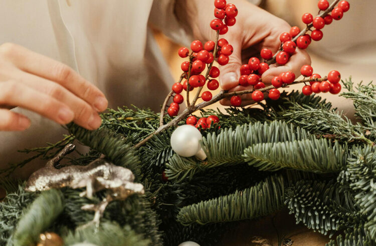 Making a Christmas wreath with foliage and berries