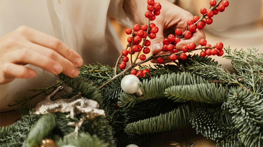 Making a Christmas wreath with foliage and berries