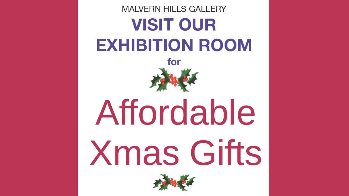 Text reads "Malvern Hills Gallery - visit our exhibition room for affordable Xmas gifts" with two images of holly shown next to text