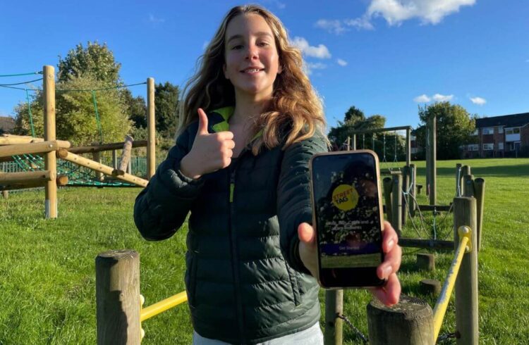 A child holding a phone in a play area