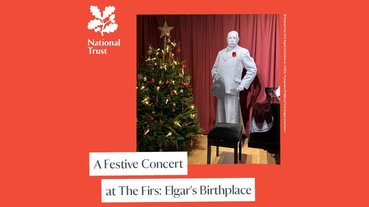 A cut-out figure of Elgar standing next to a piano and Christmas tree