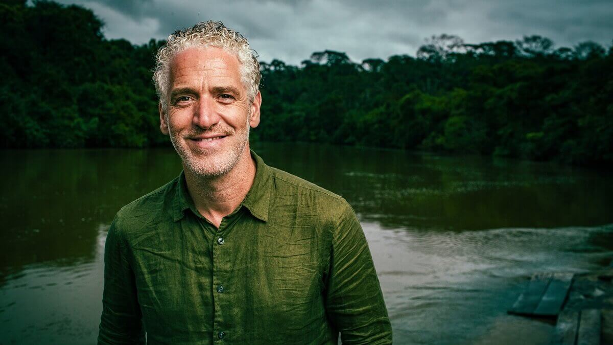 Gordon Buchanan dressed in a green shirt (background includes water and trees)