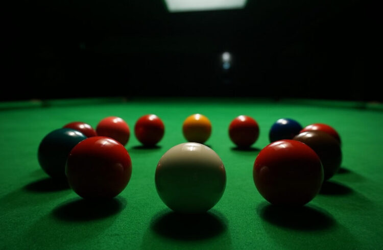 Snooker balls (white, red, green blue, yellow) on a green snooker table