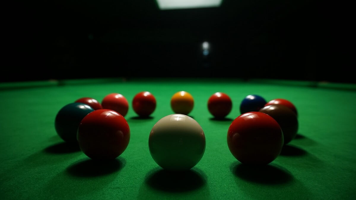 Snooker balls (white, red, green blue, yellow) on a green snooker table