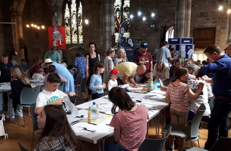 Families working on craft projects in a church