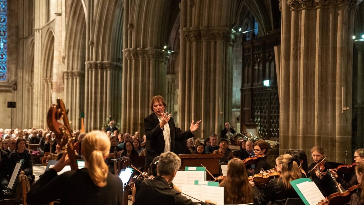 A conductor and orchestra in Worcester Cathedral as part of the Elgar Festival (image copyright Michael Whitefoot)